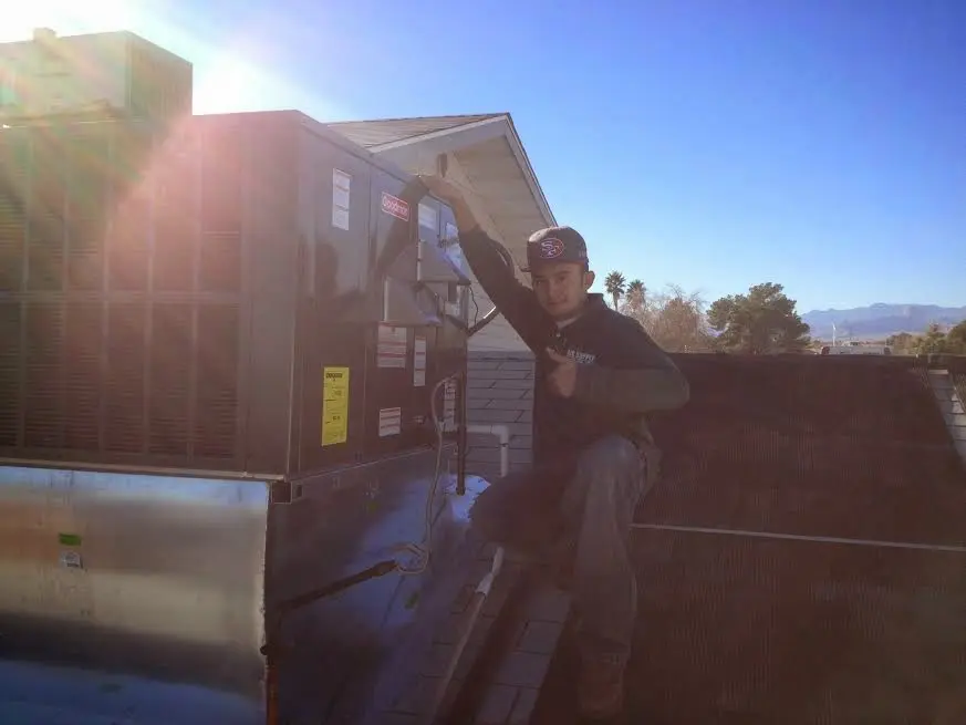 HVAC technician performing AC Tune-Up on a rooftop unit in Murfreesboro